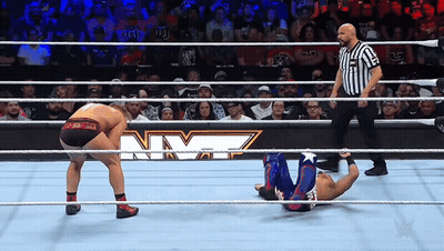 Wrestler Lying On Ground Referee Looking On GIF