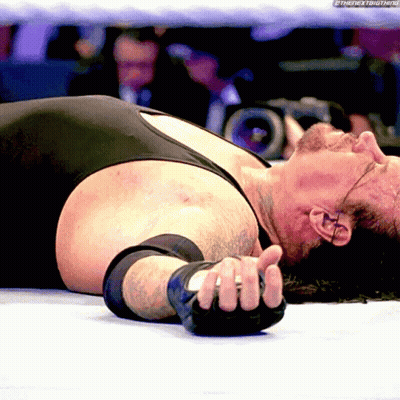 Wrestler Lying On Ground With Hand On Face GIF