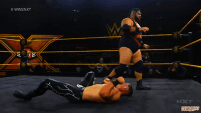 Wrestler Lying On Ground With Referee Behind GIF