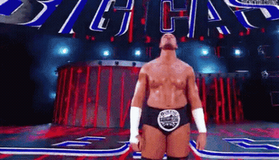 Wrestler On Stage With Sign Saying Big Chas GIF