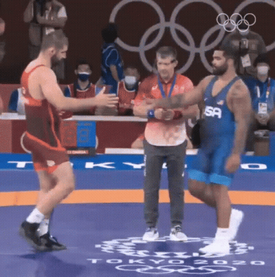 Wrestler Shaking Hands On Mat GIF
