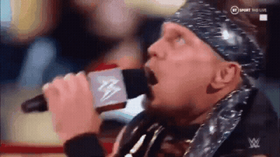 Wrestler Singing Into Microphone With Bandana GIF