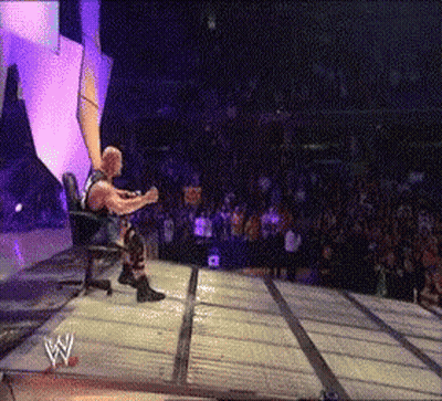 Wrestler Sitting In Chair On Stage With Crowd GIF