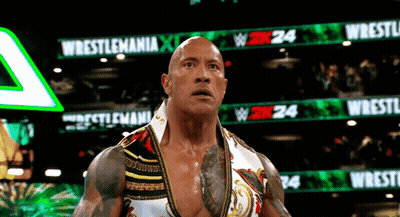 Wrestler Standing In Front Of Wrestlemania Sign GIF