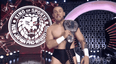 Wrestler Standing In Front Of Wrestlemania Sign GIF