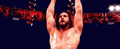 Wrestler Standing In Front Of Wrestling Sign GIF