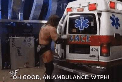 Wrestler Standing Next To Ambulance Talking GIF