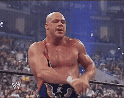 Wrestler Standing Next To Wrestler Lying On Ground GIF