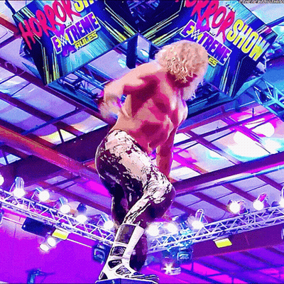 Wrestler Standing On Rope In Front Of Horror Show Sign GIF