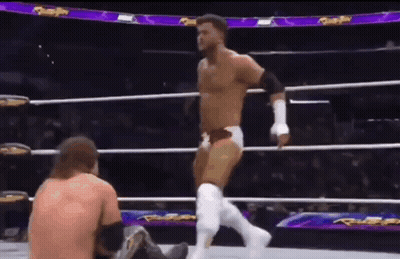 Wrestler Standing Over Seated Wrestler GIF