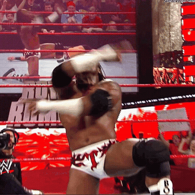 Wrestler Talking Into Microphone While Another Watches GIF