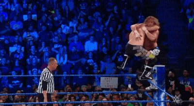 Wrestler Upside Down In Ring While Referee Looks On GIF