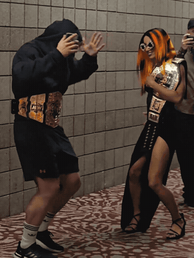 Wrestler With AEW Belt Next To Another Wrestler GIF