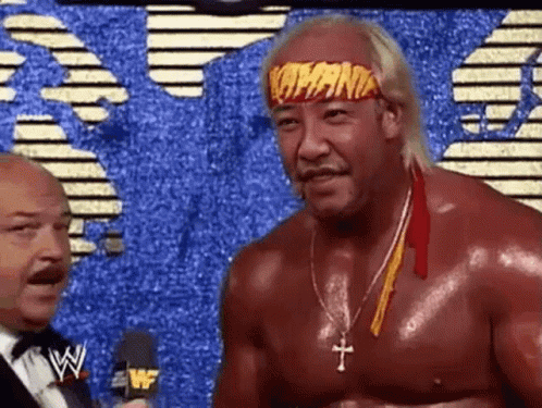 Wrestler With Headband Talking To Suit GIF