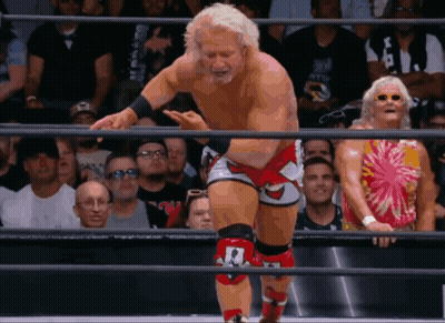 Wrestler With Number 1 On Knee In Ring GIF