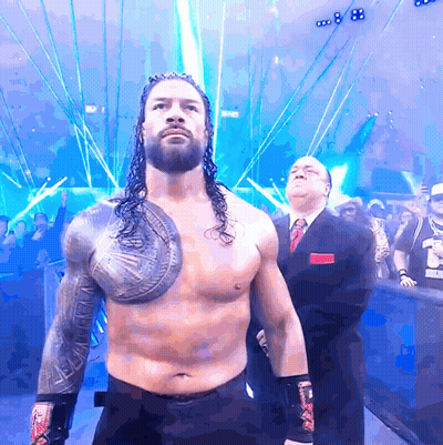 Wrestler With Shield In Front Of Crowd And Referee GIF
