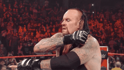 Wrestler With Undertaker Gloves Tongue Out GIF