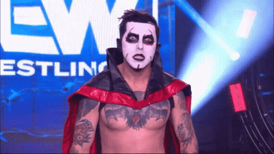 Wrestler With White Face And Red Cape GIF