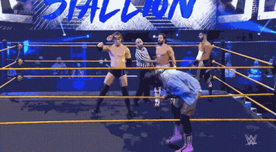 Wrestlers In A Ring With A Sign That Says # 205 Live GIF