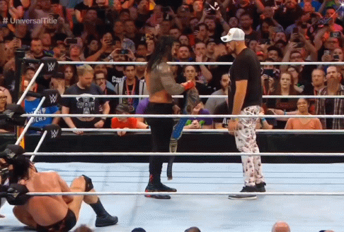 Wrestlers In A Ring With The Words Universal Title On The Bottom Right GIF
