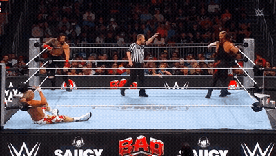 Wrestlers In A Wrestling Ring With A Sign That Says Saucy On It GIF