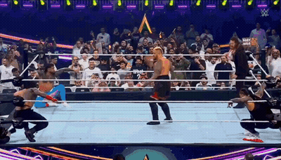 Wrestlers In Ring With Crowd And Mart Gold Sign GIF
