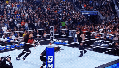 Wrestlers In Ring With Smack Down Sign GIF