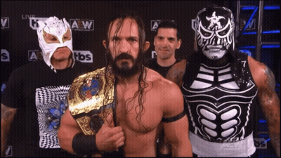 Wrestlers Posing In Front Of TBS Logo GIF