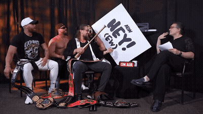 Wrestlers Sitting Around Table Saying Hey AEW GIF