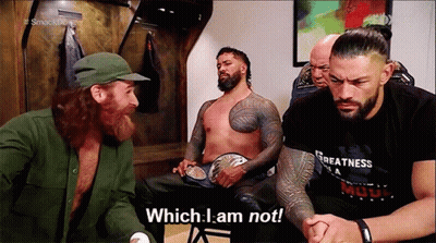 Wrestlers Sitting One Holding Belt GIF