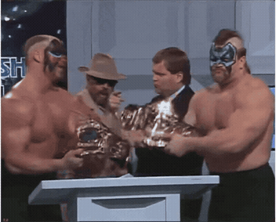 Wrestlers Standing Around Podium With Sh Sign GIF