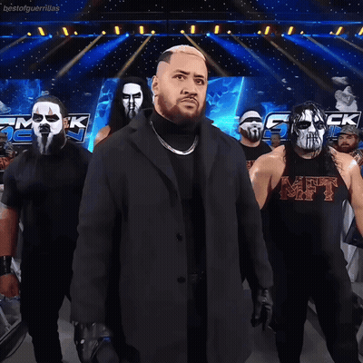 Wrestlers Standing In Front Of Bestofguerrillas Sign GIF