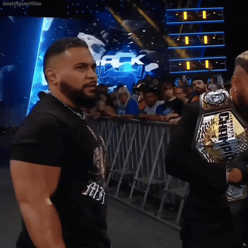 Wrestlers Standing In Front Of Mack Down Sign GIF
