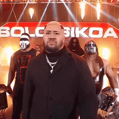 Wrestlers Standing In Front Of Solo Bikoa Banner GIF
