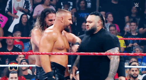 Wrestlers Standing in Ring Talking