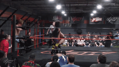 Wrestling Match In Front Of Fire Sign GIF