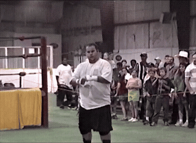 Wrestling Ring With Coach Cattano Sign GIF