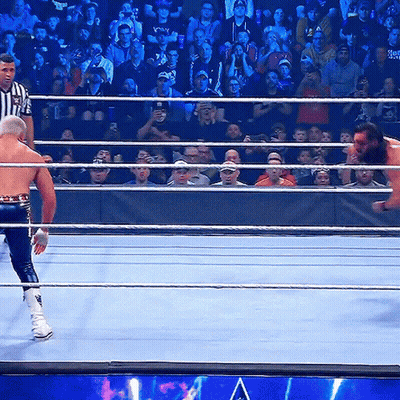 Wrestling Ring With Referee And Wrestler Holding Smackdown Belt GIF