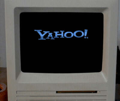 Yahoo Logo On Computer Screen With Hand Pointing GIF