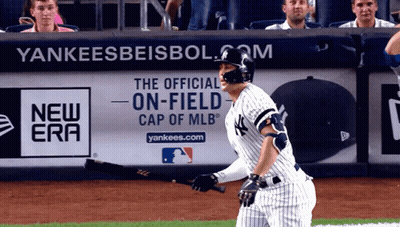 Yankees Player Holding Bat In Front Of Advertisement GIF