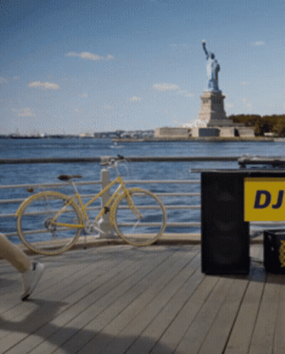 Yellow Bicycle Parked Next To DJ Table GIF