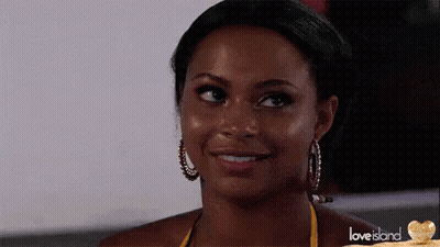 Yellow Bikini Woman Smiling At Camera With Hoop Earrings GIF