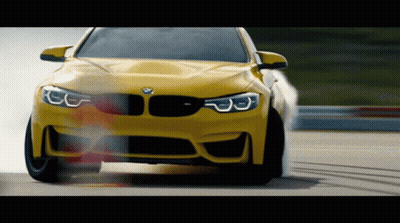 Yellow BMW Driving Down Track GIF