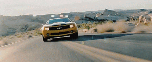 Yellow Car Driving Down Desert Road GIF