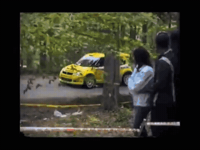 Yellow Car Driving Down Road Woman Taking Picture GIF