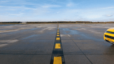 Yellow Car On Runway With Black And Yellow Stripe GIF
