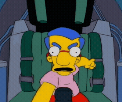 Yellow Cartoon Character With Blue Hair Sitting In Green Seat GIF