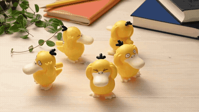 Yellow Duck Figurines On Wooden Table GIF