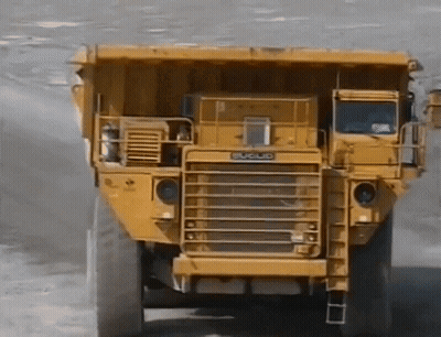 Yellow Dump Truck By Building Saying Matsu GIF