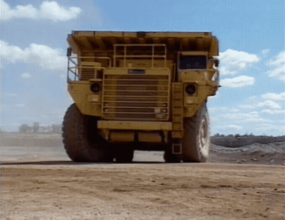 Yellow Dump Truck On Dirt Road GIF
